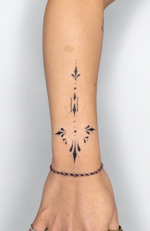 Fine line ornamental tattoo on forearm in Cusco